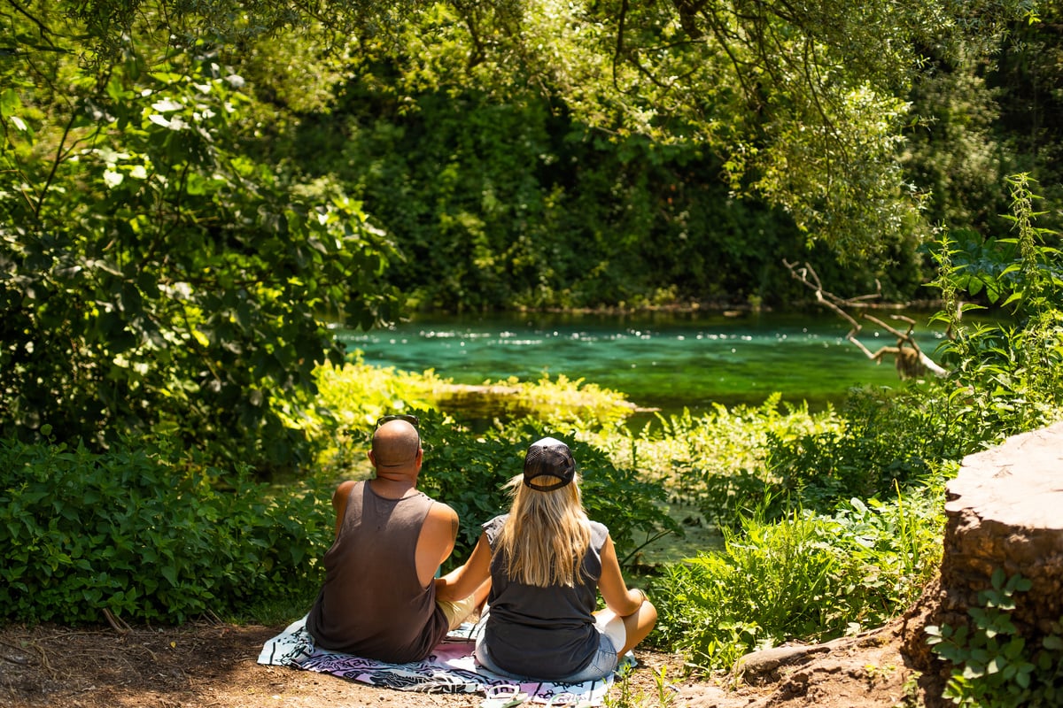 2 couple resting by river