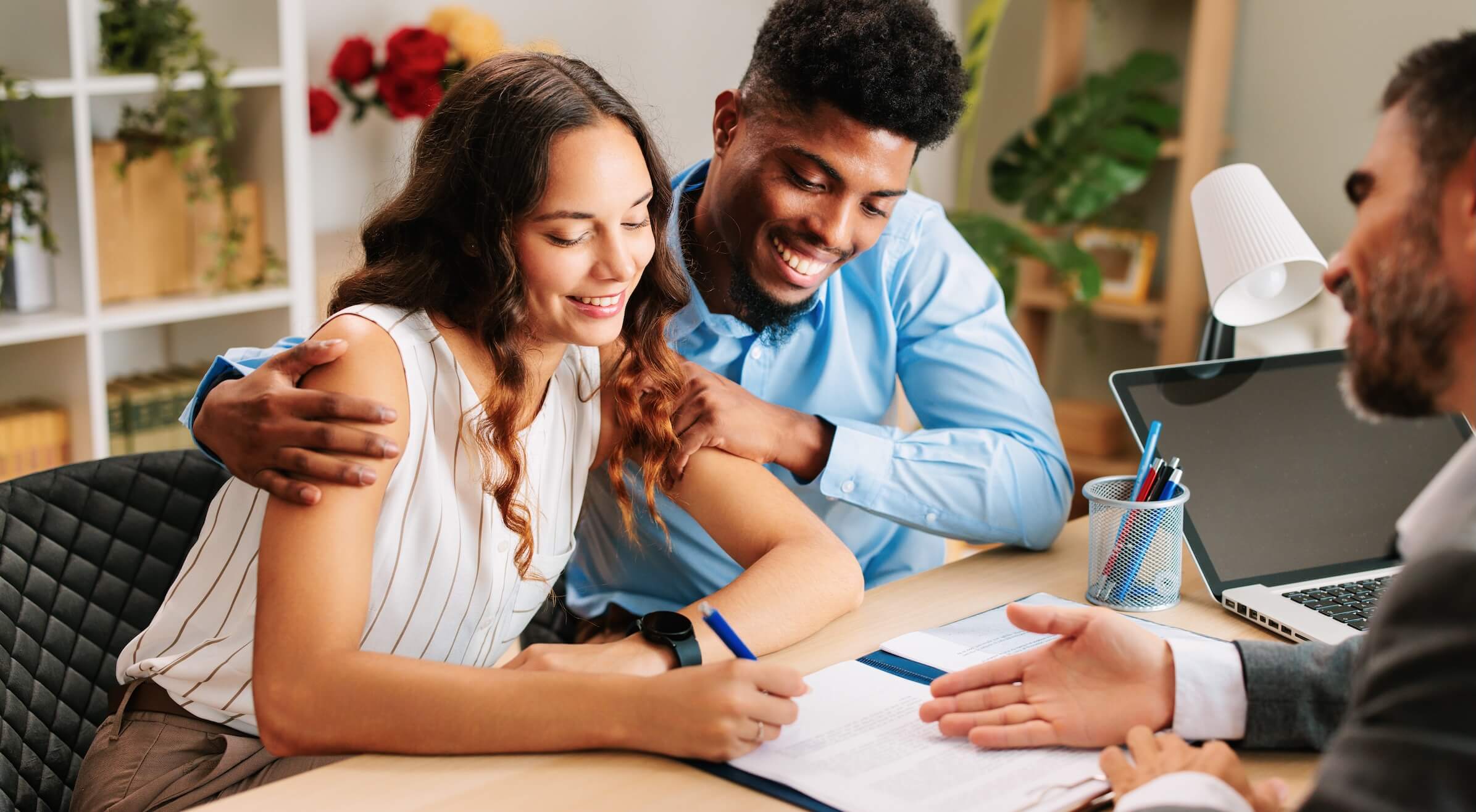 Male and female tenants signing a lease renewal document for their rental property