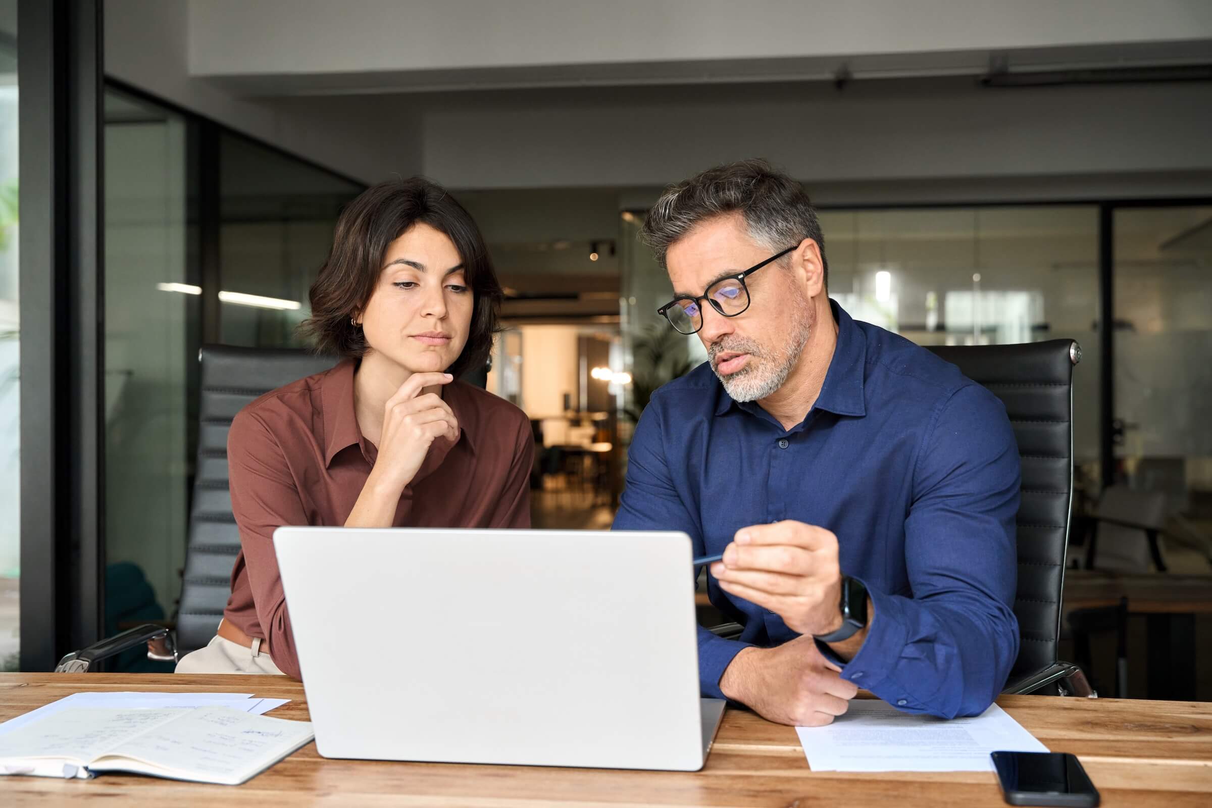 Two real estate investors review exit strategy documents for Florida rental portfolio