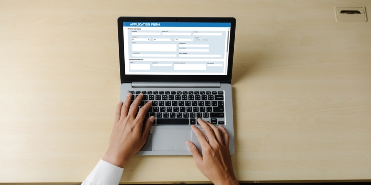 An application form on a laptop screen on a desk - featured_image